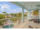 Spacious balcony with comfortable seating area overlooking a lush backyard and pool at 604 S Atlantic Ave, New Smyrna Beach, FL 32169