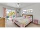 Bedroom with pastel decor and private balcony overlooking lush greenery at 604 S Atlantic Ave, New Smyrna Beach, FL 32169