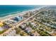 A picturesque aerial view of a coastal community with a long beach and diverse real estate at 604 S Atlantic Ave, New Smyrna Beach, FL 32169