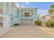 Coastal home showcasing a garage, balcony, and inviting architecture in a vibrant neighborhood at 604 S Atlantic Ave, New Smyrna Beach, FL 32169