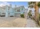 Coastal home showcasing a garage, balcony, and inviting architecture in a vibrant neighborhood at 604 S Atlantic Ave, New Smyrna Beach, FL 32169