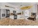 Bright kitchen featuring granite countertops, white cabinetry, stainless appliances, and coastal accents at 604 S Atlantic Ave, New Smyrna Beach, FL 32169