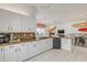 Contemporary kitchen and dining area with white cabinets, granite countertops, and an open layout at 604 S Atlantic Ave, New Smyrna Beach, FL 32169