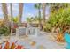 Outdoor kitchen area featuring a built-in grill, countertop space, and lush landscaping at 604 S Atlantic Ave, New Smyrna Beach, FL 32169