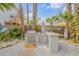 Outdoor kitchen area featuring a built-in grill, countertop space, and surfboard decor at 604 S Atlantic Ave, New Smyrna Beach, FL 32169