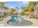 Beautiful outdoor pool area with lush tropical landscaping, perfect for relaxation and entertainment at 604 S Atlantic Ave, New Smyrna Beach, FL 32169