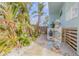 Landscaped walkway with lush greenery, surfboard accents, and a charming tropical ambiance at 604 S Atlantic Ave, New Smyrna Beach, FL 32169