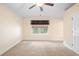 Comfortable bedroom with neutral carpet, ceiling fan, and sunlit window at 634 Coral Trace Blvd, Edgewater, FL 32132