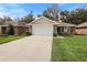 Charming single-story home with a well-manicured lawn and a two-car garage at 634 Coral Trace Blvd, Edgewater, FL 32132
