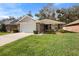 Charming single-story home with a well-manicured lawn and a two-car garage at 634 Coral Trace Blvd, Edgewater, FL 32132