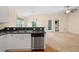 Open-concept kitchen view with stainless steel dishwasher and a seamless transition to the living area at 634 Coral Trace Blvd, Edgewater, FL 32132