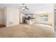 Open-concept living room with view of modern kitchen and breakfast bar seating at 634 Coral Trace Blvd, Edgewater, FL 32132