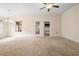 Spacious living room with neutral carpet, bright lighting, and views to adjoining rooms at 634 Coral Trace Blvd, Edgewater, FL 32132