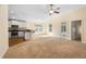 Bright living space boasts carpeted floors, white cabinets and stainless steel appliances at 634 Coral Trace Blvd, Edgewater, FL 32132