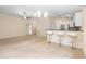 Open-concept living space with bar seating flowing into the living area at 634 Coral Trace Blvd, Edgewater, FL 32132