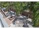 Aerial view of the backyard with a hammock, palm trees, and outdoor seating at 6443 Engram Rd, New Smyrna Beach, FL 32169