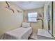 Small bedroom with a twin bed, window, and dresser, decorated with bird-themed wall art at 6443 Engram Rd, New Smyrna Beach, FL 32169