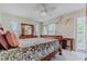 Cozy bedroom with wooden furnishings and a view of the outdoors at 6443 Engram Rd, New Smyrna Beach, FL 32169