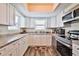 Bright kitchen with white cabinets, stone countertops, and stainless steel appliances at 6443 Engram Rd, New Smyrna Beach, FL 32169