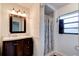 Bathroom with a dark vanity, mirror, and shower with a striped curtain at 704 Hillville Dr, Port Orange, FL 32127