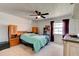 Bright bedroom featuring a ceiling fan, window, and wooden furniture at 704 Hillville Dr, Port Orange, FL 32127