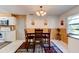 Dining room shows wood paneling, laminate flooring, and transitional style lighting at 704 Hillville Dr, Port Orange, FL 32127