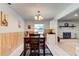 Comfortable dining area shows wood paneling, chandelier, and a fireplace nearby at 704 Hillville Dr, Port Orange, FL 32127