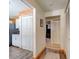 Hallway shows hardwood laminate flooring, wood trim and decorative white louvered doors at 704 Hillville Dr, Port Orange, FL 32127