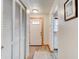 Inviting hallway with laminate flooring, closet, and decorative front door with light-wood trim at 704 Hillville Dr, Port Orange, FL 32127