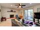 Bright living room with fireplace, ceiling fan, and sliding glass doors to outdoor space at 704 Hillville Dr, Port Orange, FL 32127