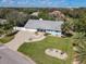 Beautiful home featuring a charming light blue exterior, lush landscaping, and a picturesque neighborhood surrounded by mature trees at 86 Rains Ct, Ponce Inlet, FL 32127