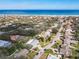 An aerial view of a coastal neighborhood with lush trees and several houses and a road running through the community at 86 Rains Ct, Ponce Inlet, FL 32127