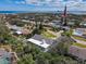 Aerial view of a neighborhood near the water with lush trees and a glimpse of a lighthouse in the distance at 86 Rains Ct, Ponce Inlet, FL 32127