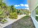 Sideyard showcasing manicured landscaping, grass and crushed shell at 86 Rains Ct, Ponce Inlet, FL 32127