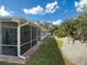 Exterior view of the home's screened patio and manicured landscaping at 86 Rains Ct, Ponce Inlet, FL 32127