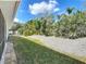 Sideyard showcasing manicured landscaping, grass and crushed shell at 86 Rains Ct, Ponce Inlet, FL 32127