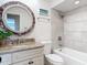 This bathroom features tiled shower walls, stone countertops, and a vanity sink at 86 Rains Ct, Ponce Inlet, FL 32127