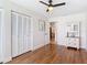 Bedroom featuring hardwood floors, a ceiling fan, and a closet with white doors at 86 Rains Ct, Ponce Inlet, FL 32127