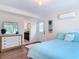 Comfortable bedroom with a double bed, dresser, a mirror, and a door leading to a bathroom at 86 Rains Ct, Ponce Inlet, FL 32127