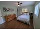 This bedroom has light green walls, wood floors, and a large dresser at 86 Rains Ct, Ponce Inlet, FL 32127