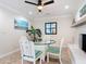 Cozy dining room featuring a glass table, striped chairs, and a decorative fireplace with mantel at 86 Rains Ct, Ponce Inlet, FL 32127