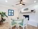 Bright dining room with a glass table, chairs with striped cushions, and a decorative fireplace at 86 Rains Ct, Ponce Inlet, FL 32127