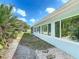 Exterior shot of the home showing well-maintained landscaping and many windows at 86 Rains Ct, Ponce Inlet, FL 32127