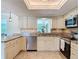 Close-up shot of a kitchen featuring granite countertops, white cabinetry, and stainless appliances at 86 Rains Ct, Ponce Inlet, FL 32127