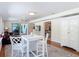 Open concept living room with dining table, view to the outdoor patio, and hardwood floors at 86 Rains Ct, Ponce Inlet, FL 32127