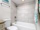 This bathroom shower features textured tile and a shower curtain at 86 Rains Ct, Ponce Inlet, FL 32127