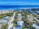 Aerial view of the blue beach home with a pool, close proximity to the beach, and nearby community at 905 Maple St, New Smyrna Beach, FL 32169