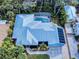 Aerial view of the property highlighting the pool, landscaping, and architectural roof design at 905 Maple St, New Smyrna Beach, FL 32169