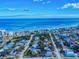 Aerial view of the neighborhood highlighting the home's coastal location, beachfront, and nearby businesses at 905 Maple St, New Smyrna Beach, FL 32169