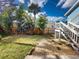 View of backyard with a wooden privacy fence, garden area, and stairs to a raised deck at 905 Maple St, New Smyrna Beach, FL 32169